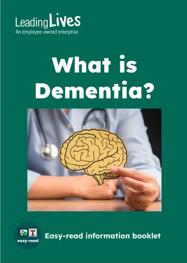cover of What is Dementia, an easy read guide created by Leading lives and Thinkclusive. The cover is dark green with white writing and shows a picture of a female doctor holding a picture of a brain